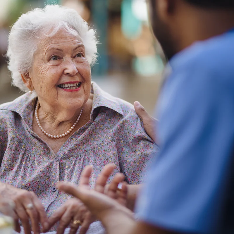 nurse-helpping-the-older-lady-smiling