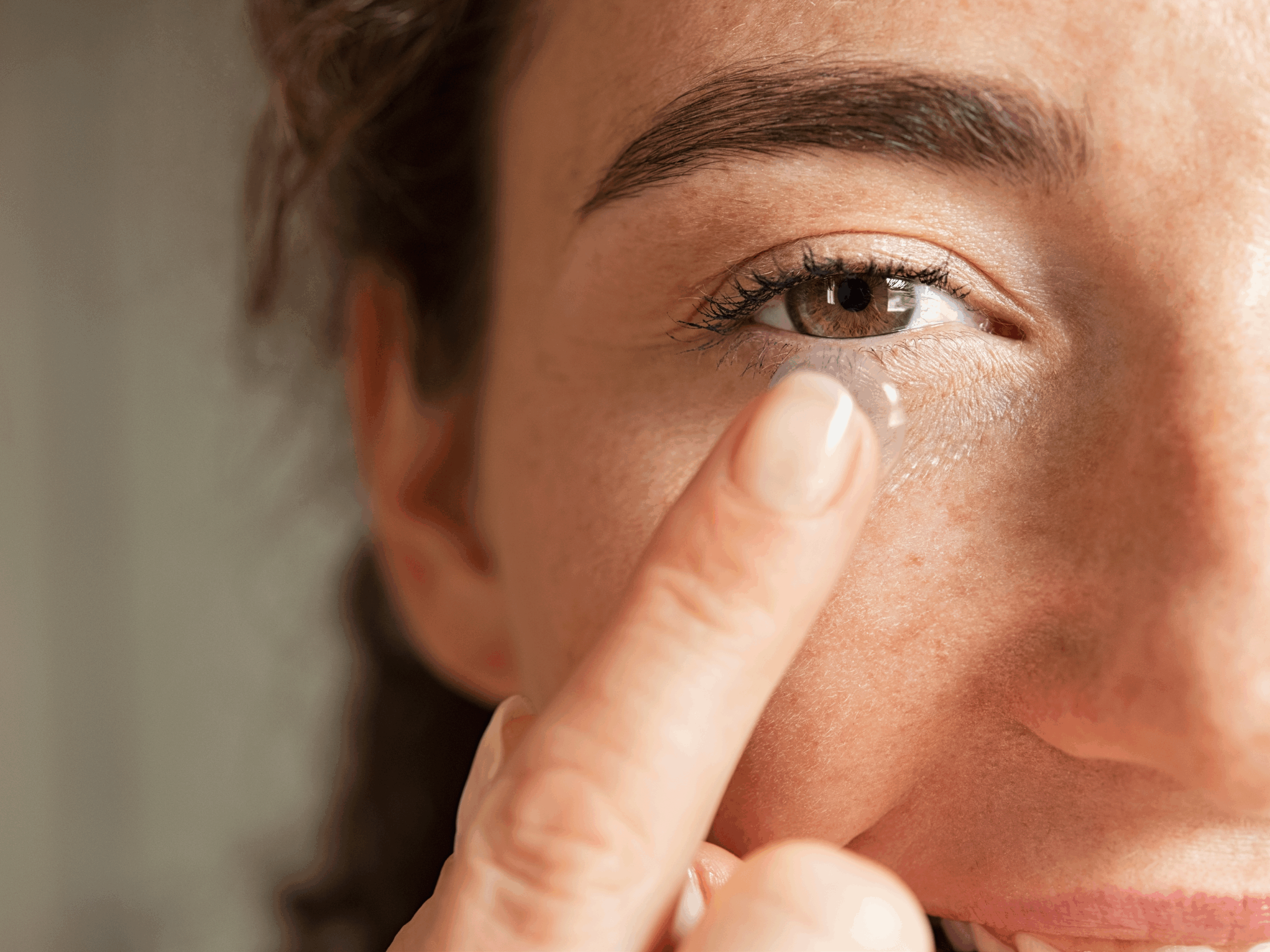 Lady Putting On Contacts Banner